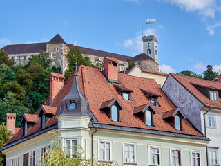 Ljubljana, Slovenia - July 28, 2023: Classical style buildings and Ljubljana Castle with a viewing...