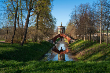 Cross bridge (Krestovy bridge) in the Alexander Park of Tsarskoye Selo on a sunny spring day,...