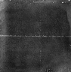 A large black and white texture of very old film, the background is dark gray with white borders, the surface has a small amount of scratches, a thin strip across it vertically,