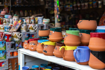 Playful character mugs on display at a souvenir shop in Cappadocia, showcasing vibrant colors and...