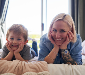 Portrait, mother and son with smile or home, bed and happy for relax, bonding and family time....