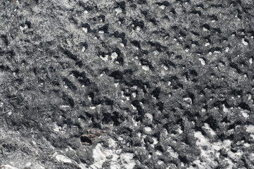 sfondo pietra superficie dura nera, grigia e bianca,  background, roccia con avvallamenti, foto...