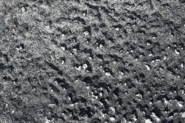 sfondo pietra superficie dura nera, grigia e bianca, roccia con avvallamenti, foto dall'alto,...