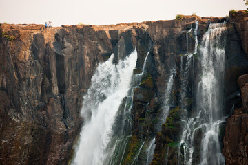 Victoria Falls, huge waterfalls of the Zambezi river flowing over sheer cliffs.