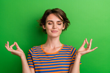 Photo portrait of attractive young woman meditation gesture closed eyes dressed stylish striped...