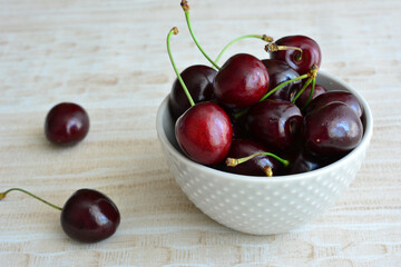cherries in bowl with a white polka dot design 