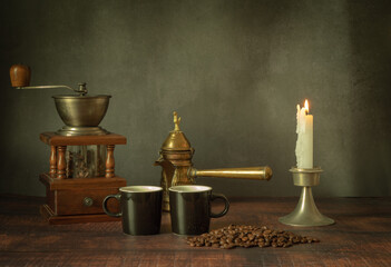Vintage stylized still life with cups of aromatic coffee and coffee beans on a wooden table.