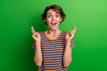 Photo portrait of lovely young lady impressed fingers crossed gesture dressed stylish striped...