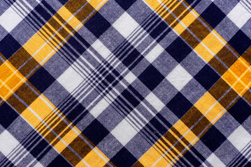 The texture of linen fabric in a large cage of blue, red, yellow and white. Scottish tailoring...