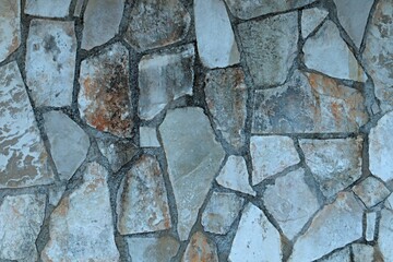 Background, texture of a wall decorated with natural stone of irregular shape
