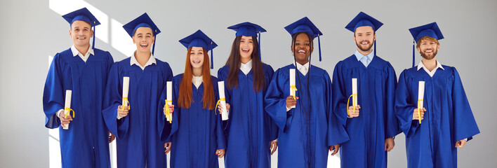 Graduate.Banner with group portrait of happy joyful smiling mixed race multiethnic university...