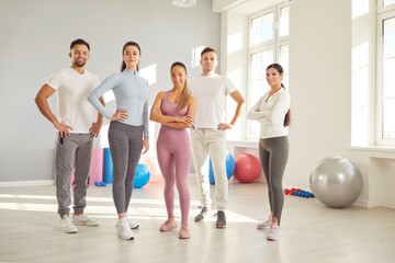 Group portrait of a team of sport people at the gym. Friends share smiles and determination, illustrating the power of togetherness in fitness journey and training sessions together.
