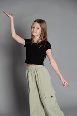 A girl extends her arm gracefully, poised and playful. Captures the innocence and dreams of youth,...