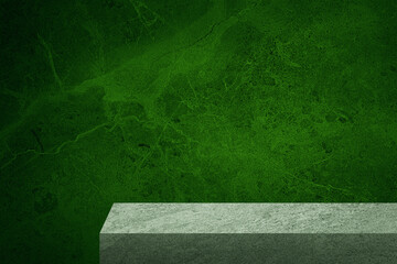 edge of grey slate stone counter with blank space for product montage display with green marble stone at background. border of stone table for decoration in modern style. front view of table.