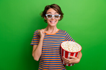Photo portrait of attractive young woman popcorn bucket raise fist dressed stylish striped clothes...