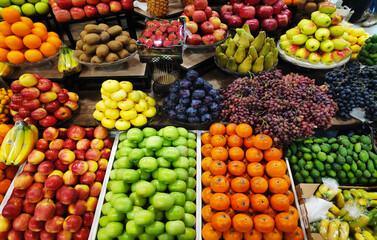 Apples, pears, pomegranates, bananas, oranges, grapes, kiwis, persimmons and other fruits on...