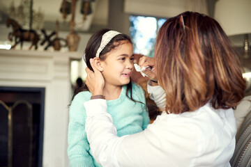 Naklejka premium Girl, crying and mother wipe tears for bullying, frustrated and failing grades in house with school difficulties. Daughter, sad and mom with tissue for family conflict, angry and puberty in home