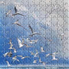 Flock of Migratory Birds Soaring Across a Boundless Blue Sky in a Jigsaw Puzzle