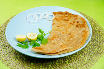 Paratha in colourful plate. Paratha on white background. Indian, Pakistani favourite Paratha.  
