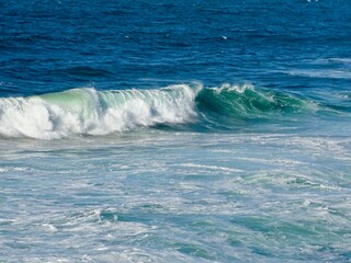 Stunning View of Emerald Waves Rolling onto Shore, a Mesmerizing Portrait of the Ocean's Ever-Changing Moods