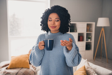 Photo of nice young woman smell fresh coffee wear blue sweater modern interior apartment indoors