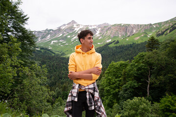 A young attractive student is resting in the mountains.