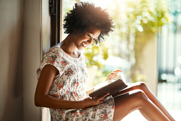 Woman, reading and book in home or relax, door way and sitting on floor for comfort with literature...