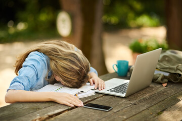Student, girl and laptop in burnout, tired or sleeping with books, cellphone and outdoor for...