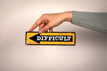 Difficult Decision Concept. Arrow with text in woman's hand on white background