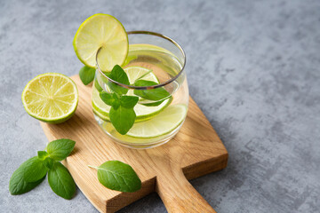 Detox water with mint leaves and lime. Healthy food rich in vitamins and antioxidants. With copy...