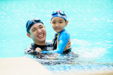 Father and son swimming together.