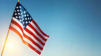 Fototapeta premium Closeup shot of a small American flag with background of blue sky.