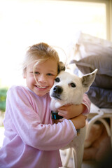 Portrait, little girl and dog with hug in home for bonding, playing and happy together. Friends, child or puppy for companion, love or caring kid as pet owner for childhood development in house