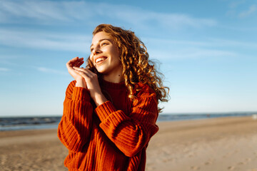 Portrait of beautiful youngfemale on the sand at the beach. Fashion, beauty, lifestyle concept.