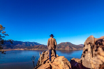 Lonely and adventurous person in front of a valley with a lake in the valley of Bravo state of Mexico 