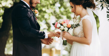 Groom and bride engagement rings during wedding ceremony