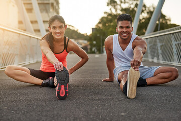 Fitness, portrait and couple stretch on bridge for health, wellness or warmup for run. Man, woman and training on road for cardio, preparation and workout together in city for marathon, jog or sprint