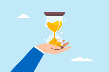 Businessman hand holds hourglass with sand fall into pile of money, illustrating time is valuable and investing for long term to gain profit and earnings. Concept of savings and salary growth