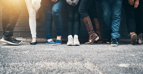 Outdoor, legs and people in row against wall while waiting, appointment and line for registration. Feet, shoes and footwear of crowd for voting outside by ground, pavement and cement in town