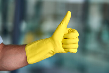 Cleaner, hands and thumbs up with gloves for housekeeping, thank you or cleaning service in office....