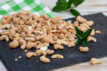 Roasted cashew nuts in bowl. Healthy snack, vegetarian food full of protein, beer snack..