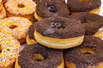 Sweet dessert variety of decorated donuts cakes in confectionery shop
