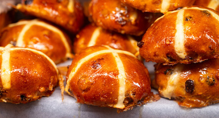 Traditional British Easter food, fresh baked cross buns with raisins or apples