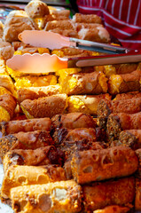 Homemade sweet pastry cannolo siciiano filled with almond, pistachio, lemon, vanilla, chocolate cream