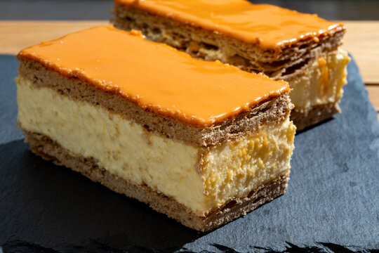 Celebration of the King birthday in Netherlands, tompoes or tompouce, iconic pastry in Netherlands made from puff dough, orange icing, cream
