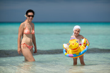 girl bathes in the ocean, swim with an inflatable toy, inflatable ring, Atlantic ocean, Cuba,...