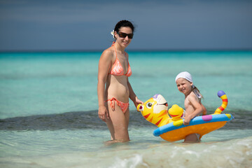 girl bathes in the ocean, swim with an inflatable toy, inflatable ring, Atlantic ocean, Cuba,...