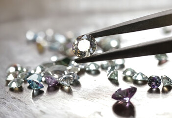 A pair of scissors smoothly cutting through a cluster of sparkling diamonds