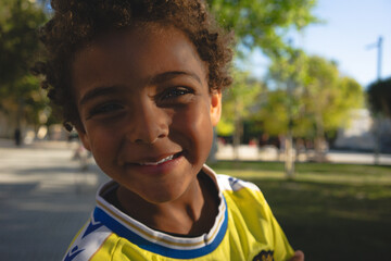 Portrait of a smiling boy. African American boy. Playing in the park with a soccer jersey. Afro hair. Happiness. Smiling