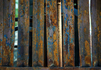 Rust on iron bar with blue and yellow color.Corrosive grunge rusted on old iron.Pattern grunged rust as illustration for presentation background.Rusty corrosion or oxidized texture.Close up.